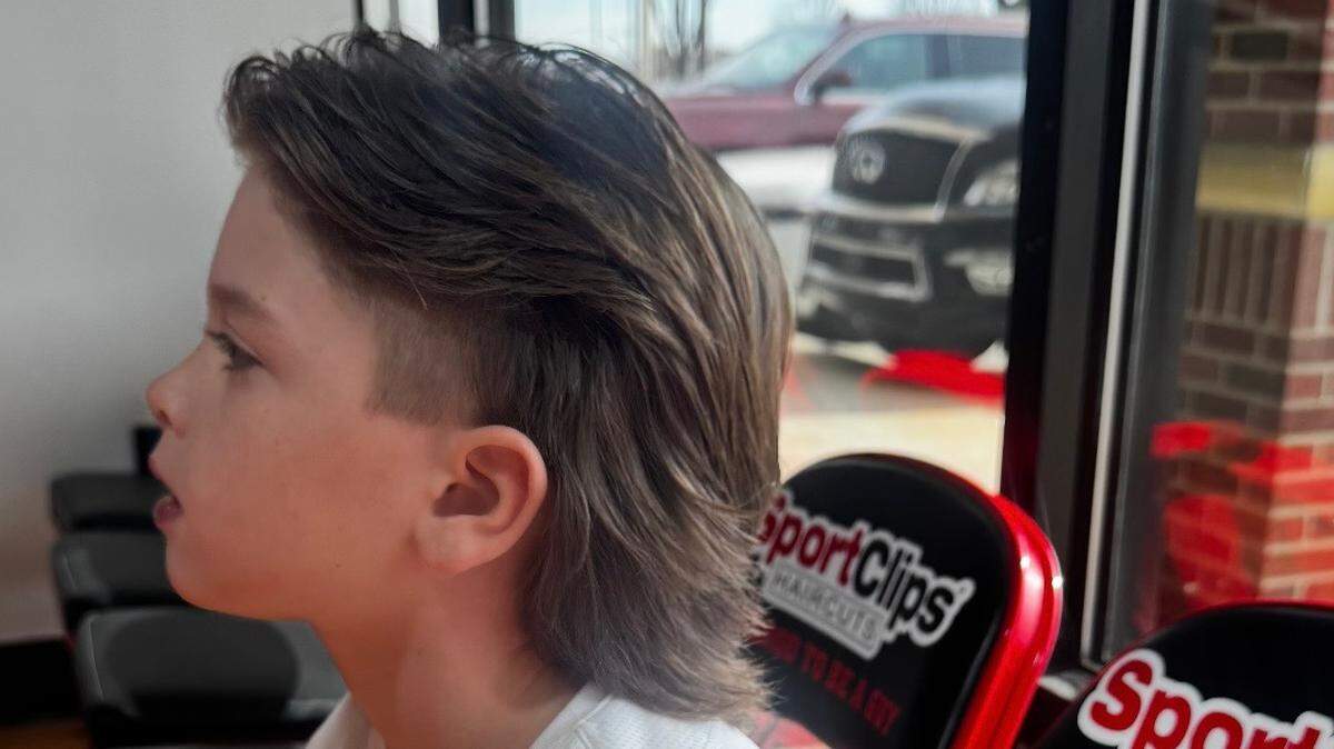 A young Royals fan named Benny shows off his hairstyle based on shortstop Bobby Witt Jr. His brothers Brooks and Bennett also have the updated version of a mullet.