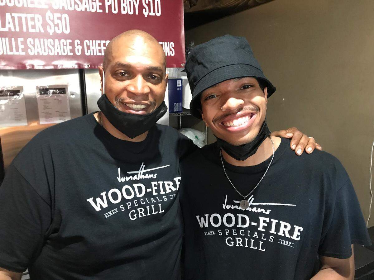 John Dawkins, left, and his son, John, are expanding their Olathe barbecue restaurant. They will have a stage for live music, comedy shows and more.