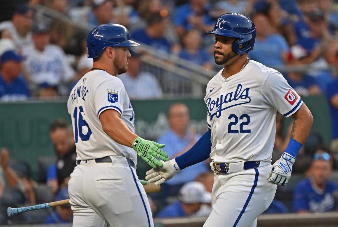 Kansas City Royals left fielder Tommy Pham (22) shakes hands with Kansas City Royals right fielder Hunter Renfroe (16) after scoring a run in the first inning against the Detroit Tigers at Kauffman Stadium on Sept. 18, 2024.