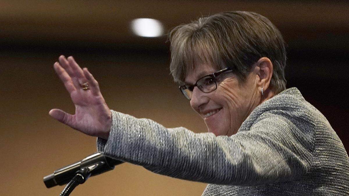 Kansas Gov. Laura Kelly waves to supporters at a watch party after calling it a night with the race too close to call, early Wednesday, Nov. 9, 2022, in Topeka, Kan. Kelly was facing Republican challenger and Kansas Attorney General Derek Schmidt. (AP Photo/Charlie Riedel)