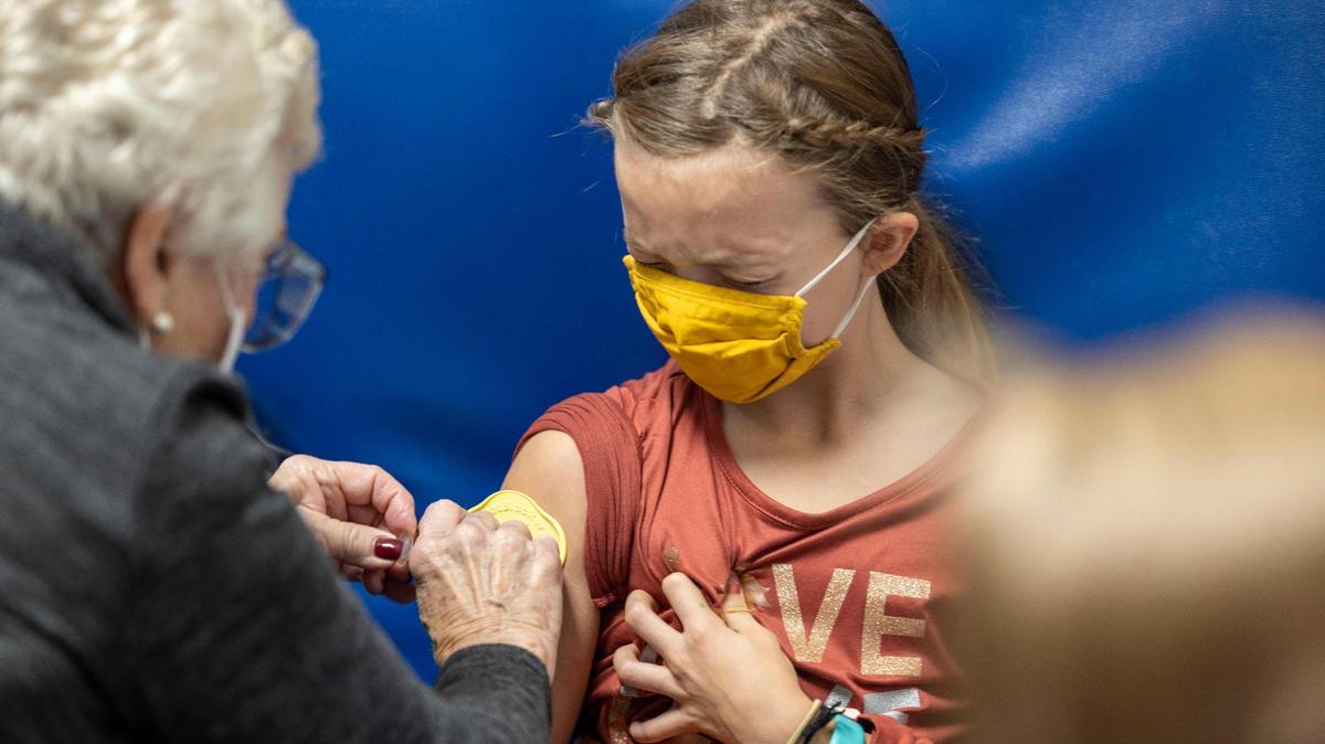 Nine-year-old Evie Edwards receives her first COVID-19 vaccine at Children’s Mercy Hospital-Kansas in Overland Park, Kansas on Saturday, Nov. 6, 2021.