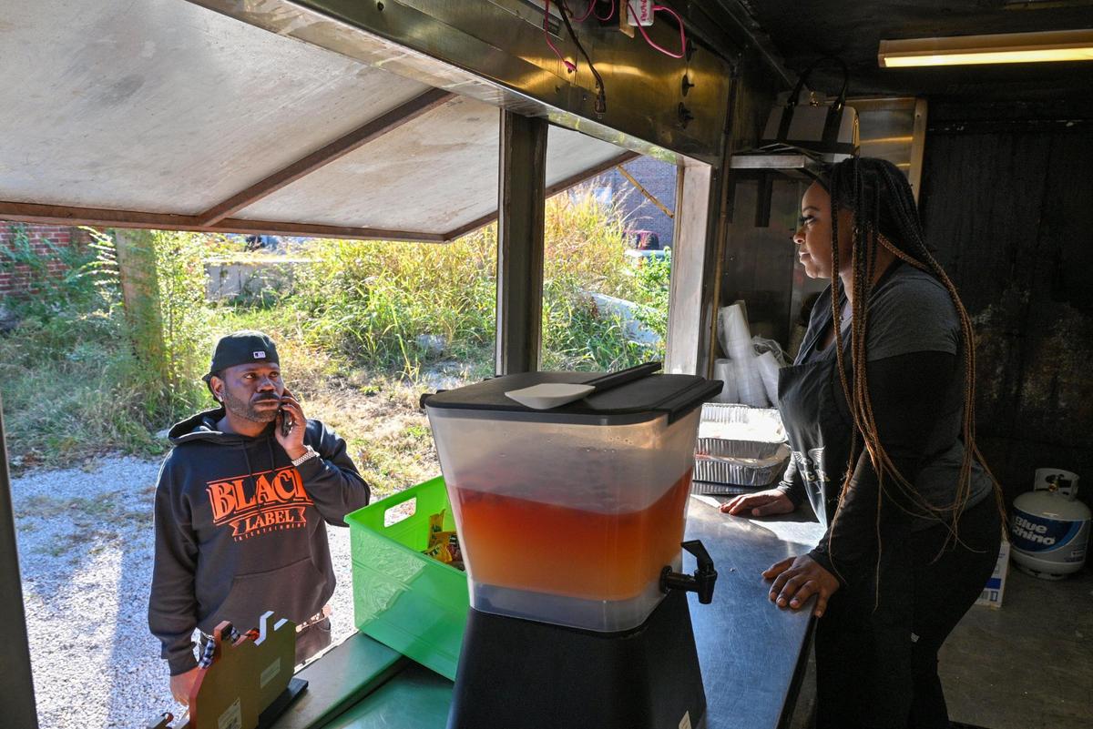 Kay Clark, owner of KC’s Wing Bar food truck, breaks the bad news to a customer that the fryer is broken and there will be no chicken wings for a Halloween event in the 18th & Vine District. But she does have lemonade.