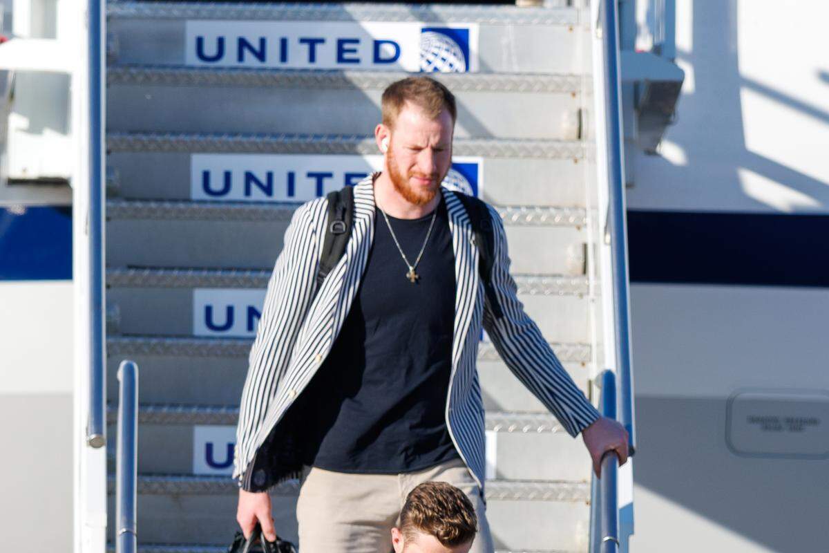 Kansas City Chiefs backup quarterback Carson Wentz (11) exits the plane after arriving at Louis Armstrong New Orleans International Airport on Feb. 2, 2025.