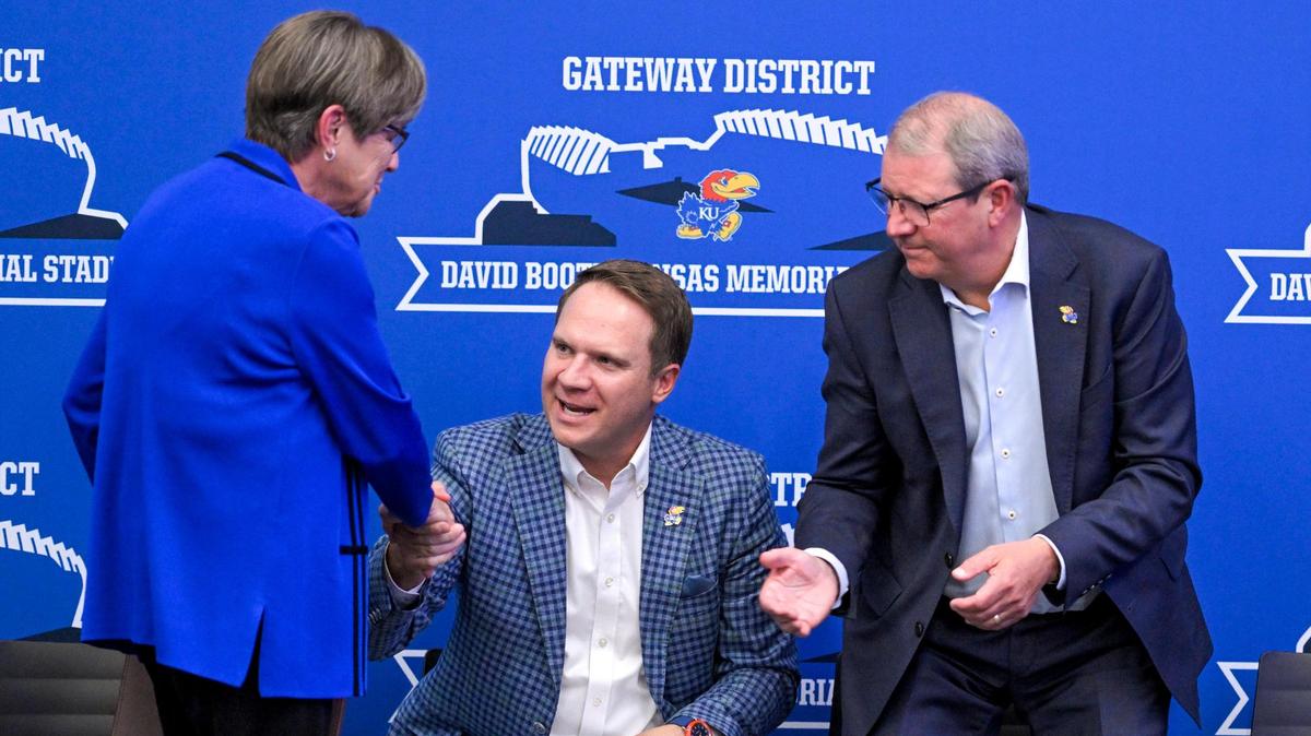Kansas Gov. Laura Kelly shakes hands with KU athletic director Travis Goff and chancellor Douglas Girod, right, after Kelly addressed the crowd regarding plans for renovations to David Booth Kansas Memorial Stadium and a campus Gateway Project in Lawrence on Aug. 15, 2023.