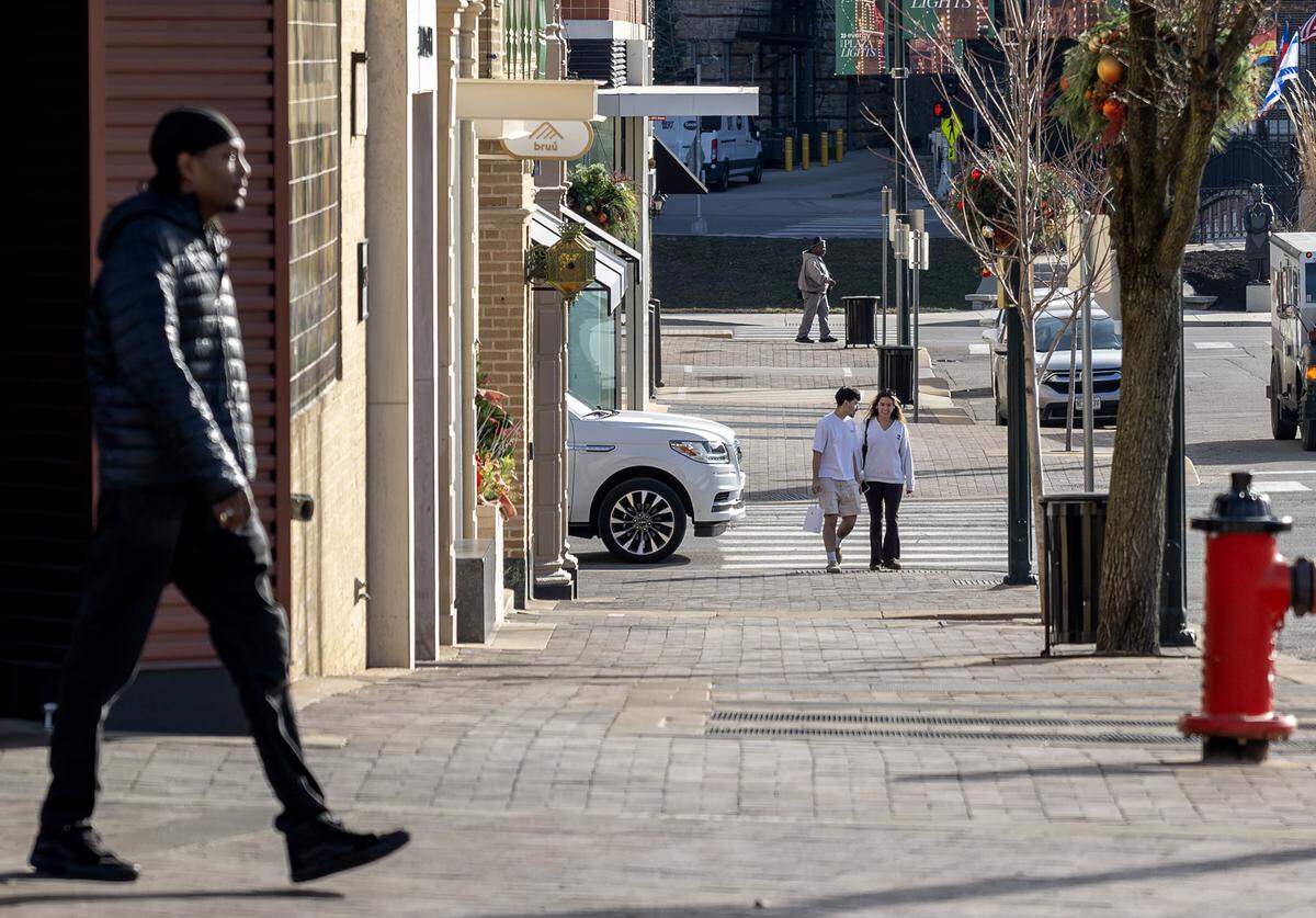 Pedestrians walk along Wyandotte Street at the Country Club Plaza on Tuesday, Dec. 16, 2025, in Kansas City.