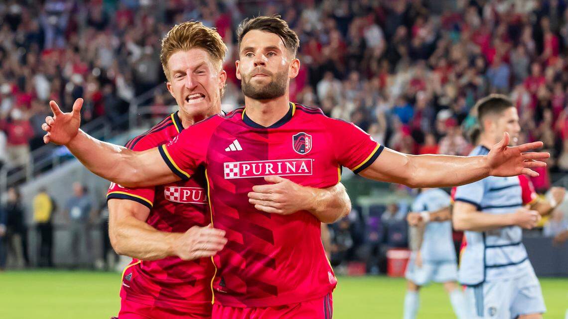 St. Louis City SC midfielder Eduard Loewen (No. 10) celebrates with teammate Tim Parker after scoring the opening goal against Sporting Kansas City on Saturday night in St. Louis.