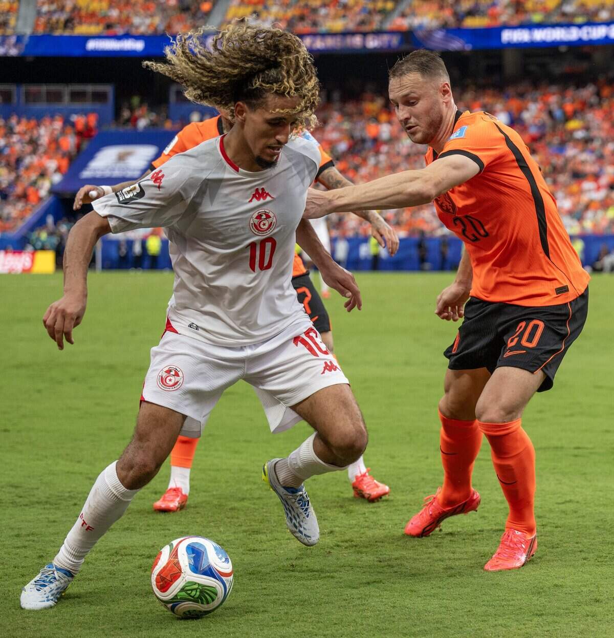 Tunisia midfielder Hannibal Mejbri (10) and Netherlands midfielder Teun Koopmeiners (20) compete for the ball during the second half of a FIFA World Cup group-stage soccer match at Kansas City Stadium on Thursday, June 25, 2026.