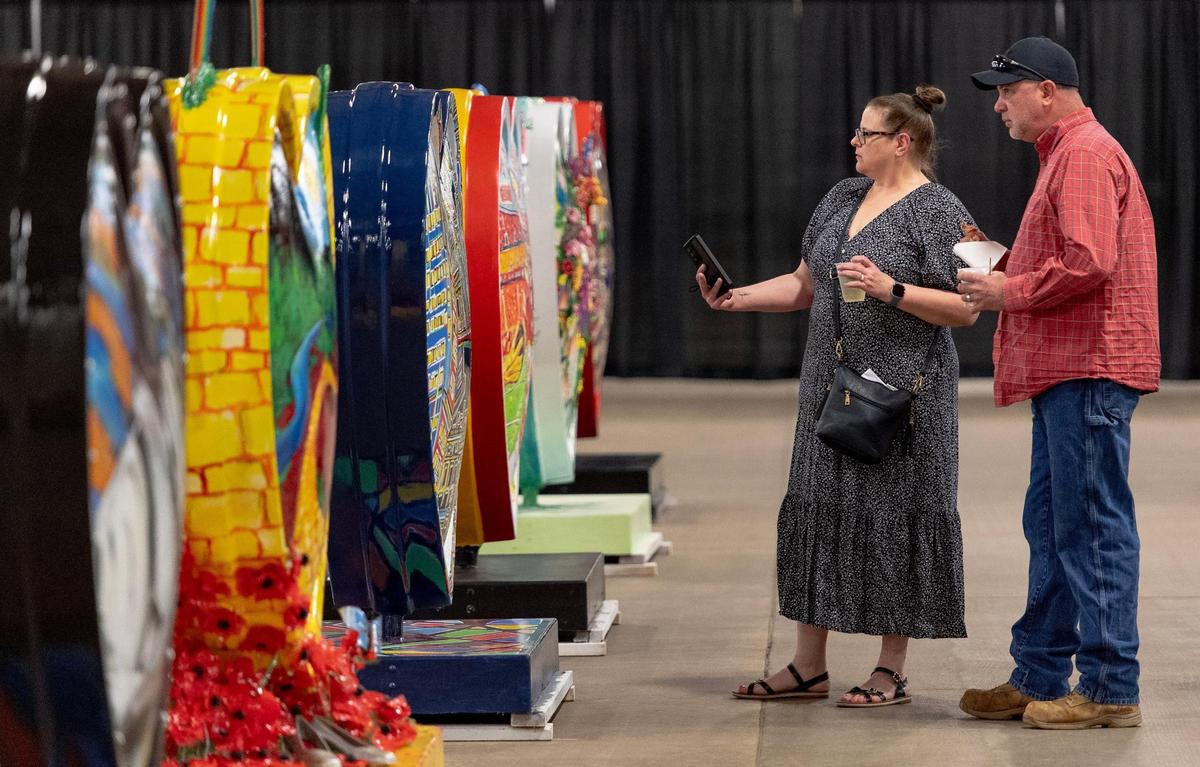 Kristie and James Roberts look at hearts on display during the Parade of Hearts Reveal Kickoff Event on Friday, April 14, 2023, in Kansas City.