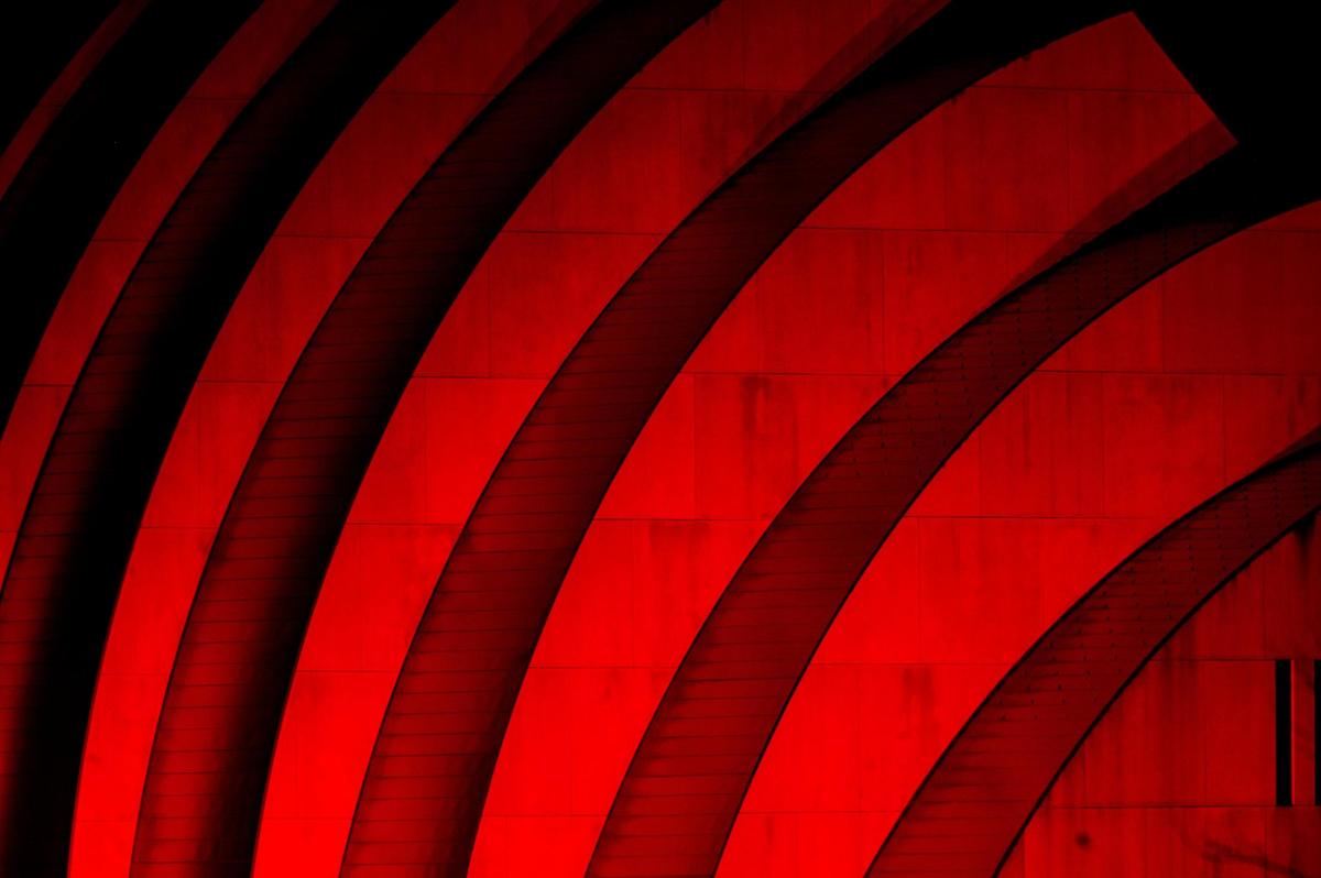 The clamshell north side of the Kauffman Center for the Performing Arts glows red to celebrate the success of the Kansas City Chiefs.