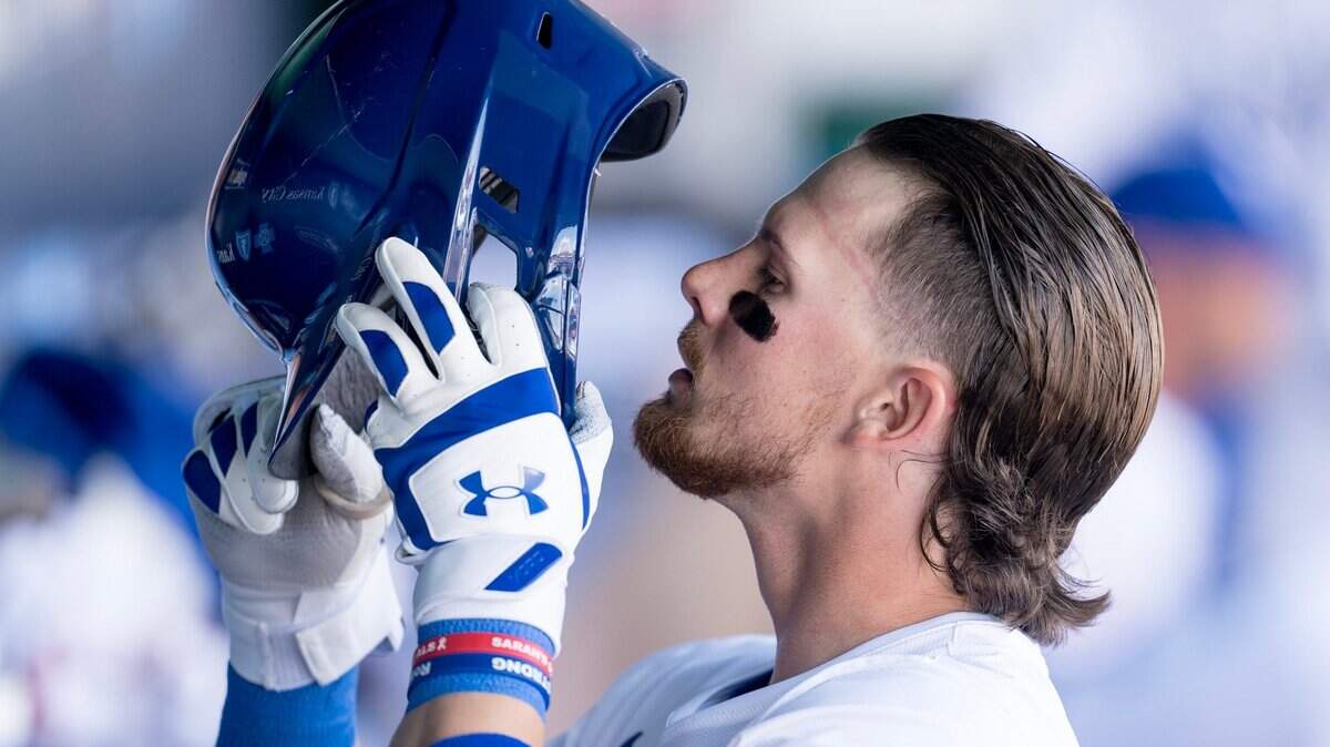 Kansas City Royals shortstop Bobby Witt Jr. dons his batting helmet in the dugout for a first-inning at-bat during the Royals’ home opener Thursday with the Minnesota Twins.