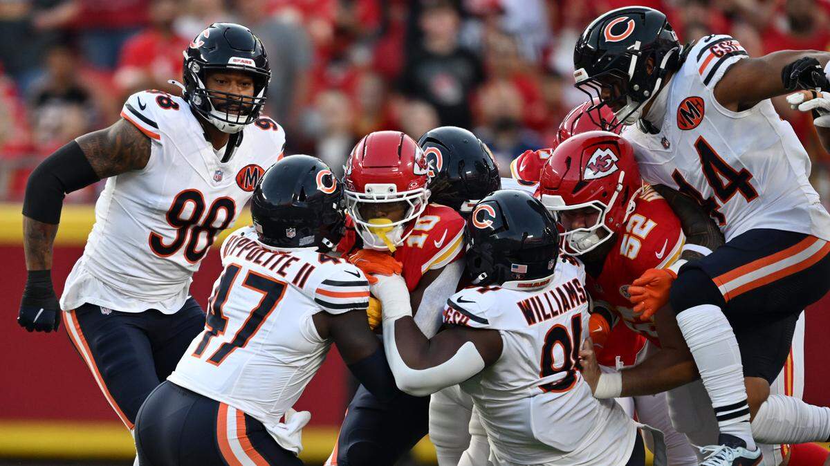 Kansas City Chiefs running back Isiah Pacheco (center) is wrapped up by Chicago Bears defenders on a run in the first quarter on Friday, Aug. 22, 2025, at GEHA Field at Arrowhead Stadium.