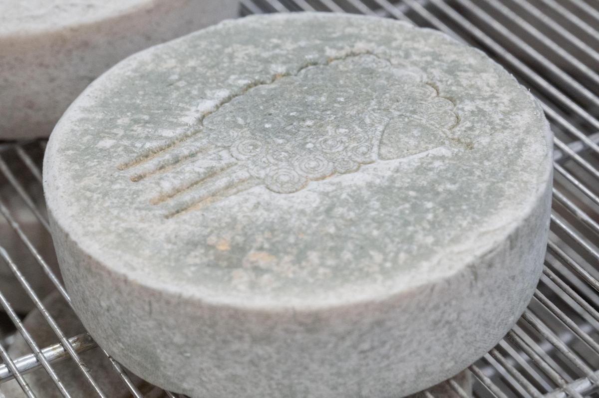 Green Dirt Farm’s Prairie Tomme, a variety of aged sheep’s milk cheese at Green Dirt on Oak bears the sheep-shaped logo that is stamped into the company’s cheeses.