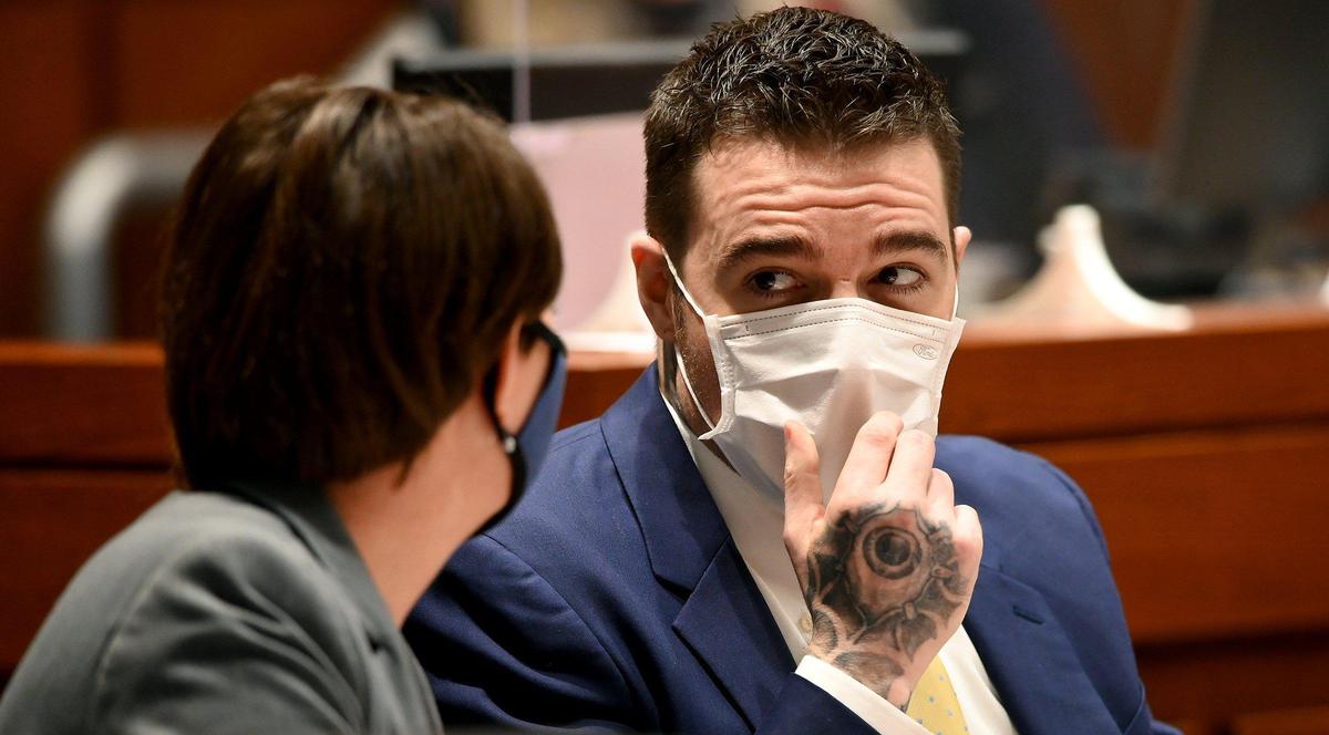 Kylr Yust speaks with attorney Molly Hastings during the third day of his murder trial in Cass County Wednesday, April 7, 2021. Yust is charged with two counts of first-degree murder in the deaths of Kara Kopetsky, 17, and Jessica Runions, 21.