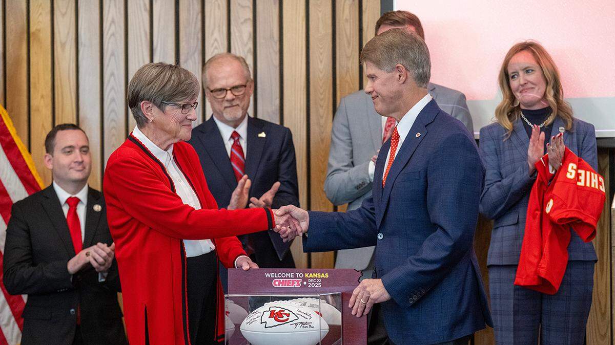 Kansas Governor Laura Kelly announced Monday, Dec. 22, 2025, in Topeka that the Kansas City Chiefs will build their new stadium in Kansas City, Kansas. Kelly presented Chiefs CEO Clark Hunt with a football as others looked on during the announcement.
