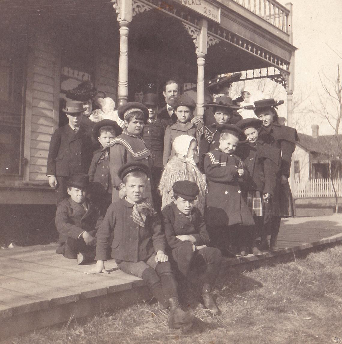 Children who rode the orphan train posed for a photo with the adults who traveled with them to facilitate the adoptions.