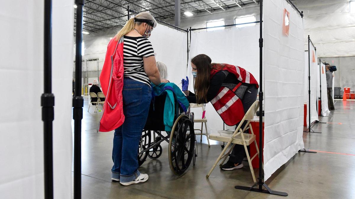 Platte County Health Department nurse Jordan Gabauer gave a COVID-19 vaccine dose to Mary Kern, 84, of Claycomo, at a mass vaccination clinic in March.