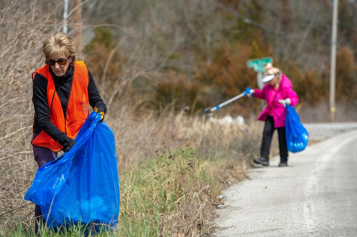 Dianne Siegel, left, and Kathy LeFrensen pick up plastic debris along East Blue Ridge Boulevard on Wednesday, March 15, 2023, in Kansas City.