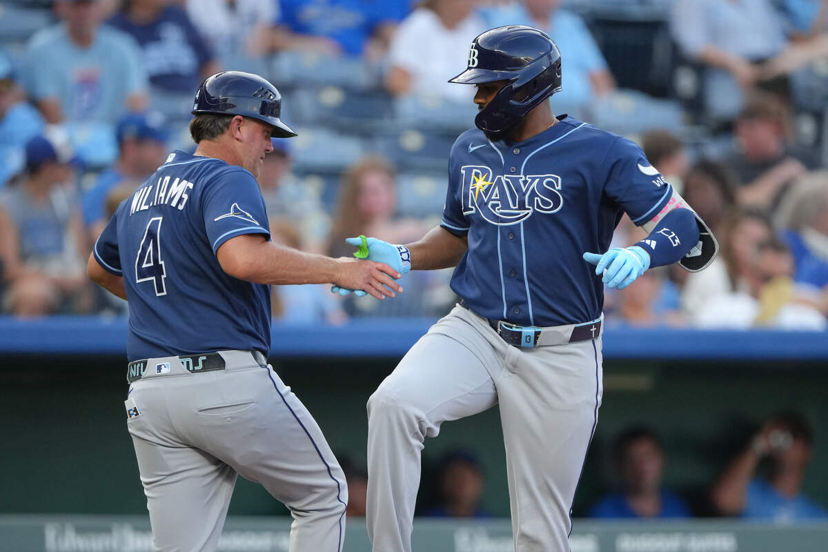 Tampa Bay’s Junior Caminero, right, celebrates his three-run home run with third-base coach Brady Williams during the third inning of the Rays’ 10-4 win against the Royals at Kauffman Stadium in Kansas City on Tuesday, June 30, 2026.