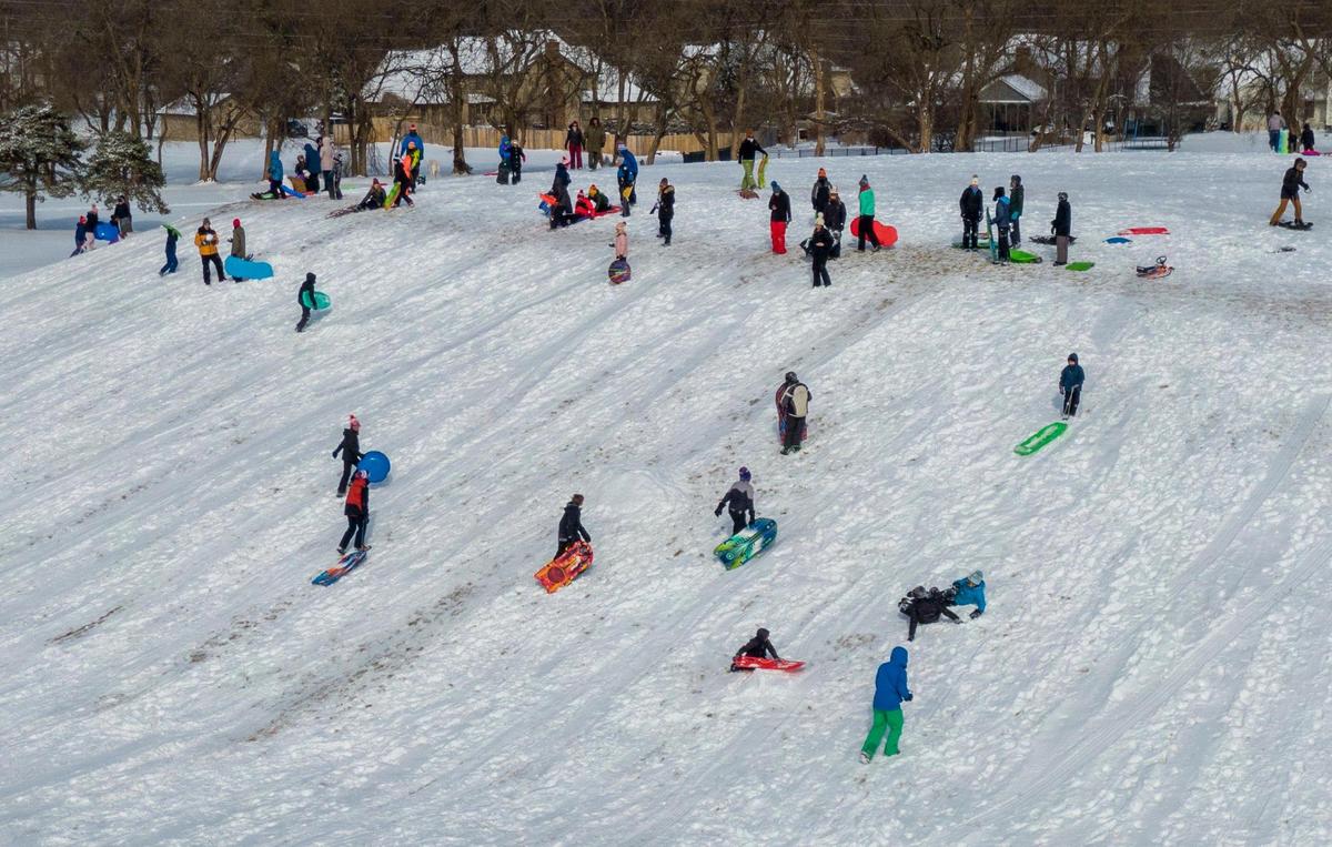 Sledders hit the hill at Meadowbrook Park on Wednesday, Feb. 2, 2022, in Prairie Village after a winter storm dropped a few inches on snow in the Kansas City metro area.
