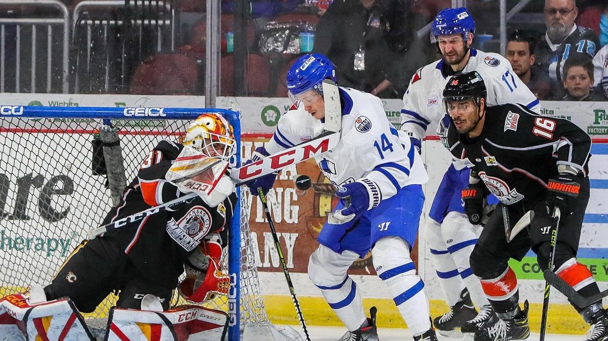 KC Mavericks and Wichita Thunder players converge on the puck in front of the Kansas City goal during Friday’s game at Intrust Bank Arena in Park City, Kan.