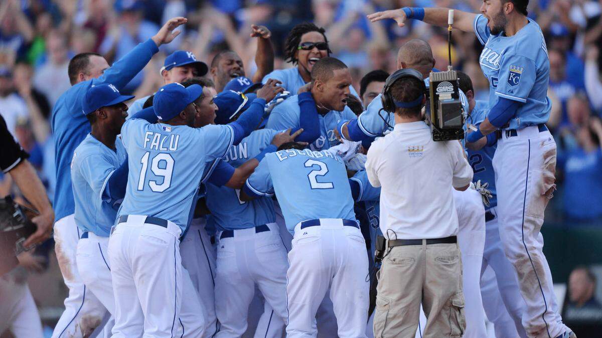 The Kansas City Royals celebrate after Justin Maxwell (center) hit a walk off grand slam against the Texas Rangers during the 10th inning at Kauffman Stadium. The Royals beat the Rangers 4-0.