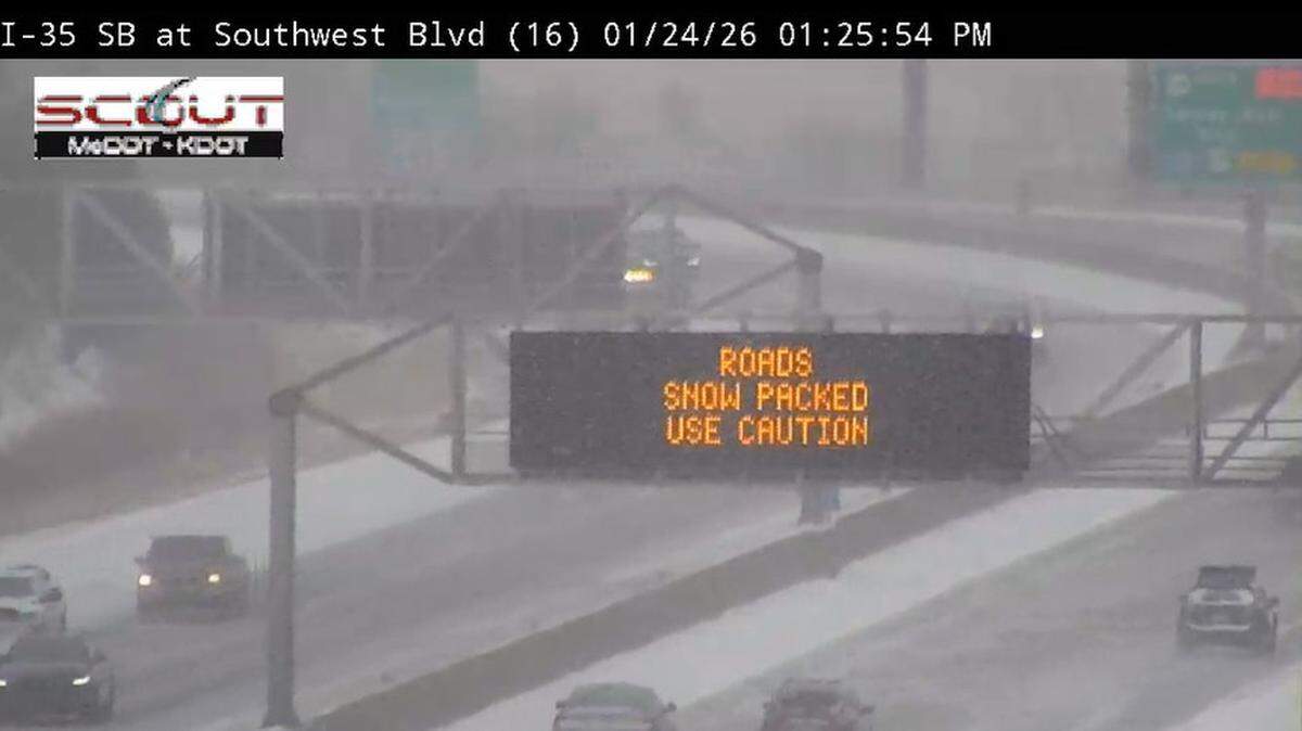 A KC Scout camera at Interstate 35 and Southwest Boulevard shows a sign warning drivers of snow-packed roads on Saturday, Jan. 24, 2026.