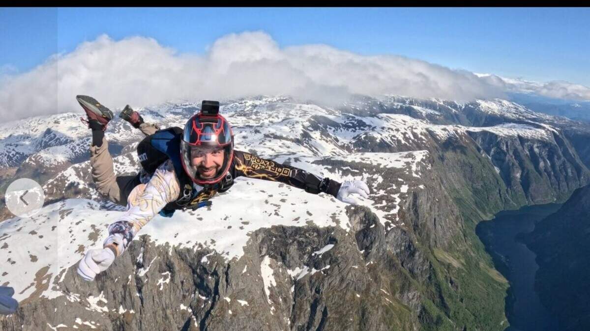 Marcus Miller, a pipefitter living in Lawrence, Kansas, pictures skydiving above a mountain range. Miller was one of 11 skydivers, along with a pilot, who died Sunday June, 14, 2026 when a skydiving plane crashed on takeoff in Butler, Missouri.