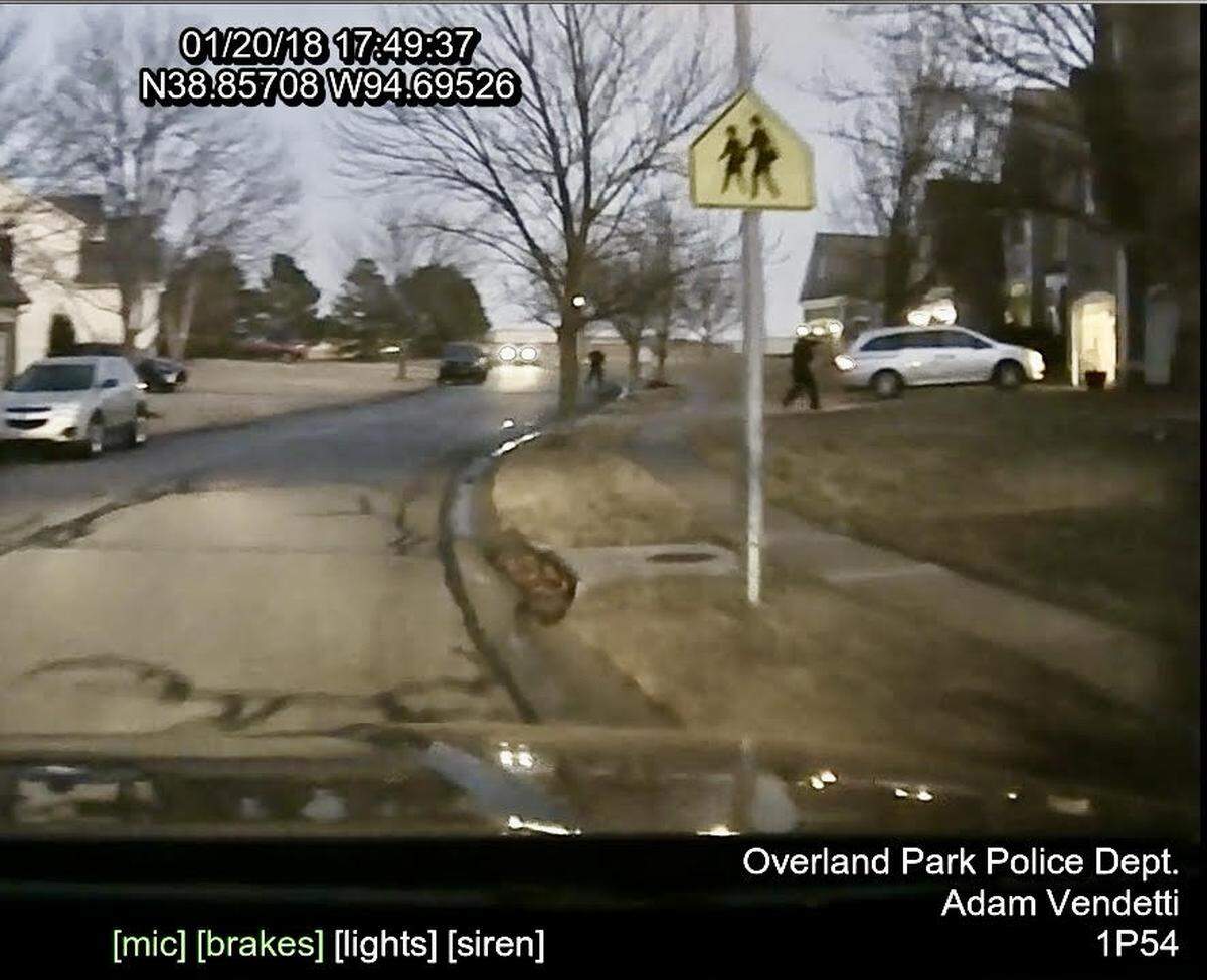 A still frame shows former Overland Park police officer Clayton Jenison shooting at a minivan driven by 17-year-old John Albers, who died. 