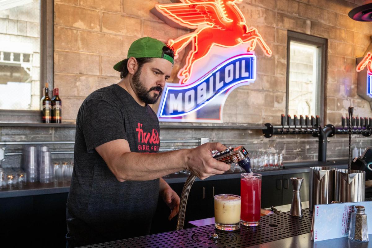 Lead bartender Jordan Lutz, mixes a couple of cocktails at Hank’s Garage and Grill in Shawnee on Monday, March 10.