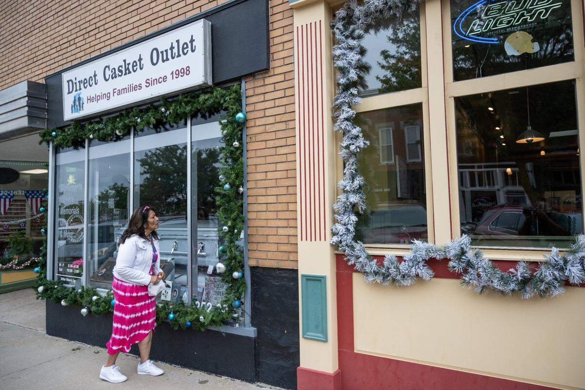A woman stops to look at Christmas decorations Wednesday in downtown Independence.
