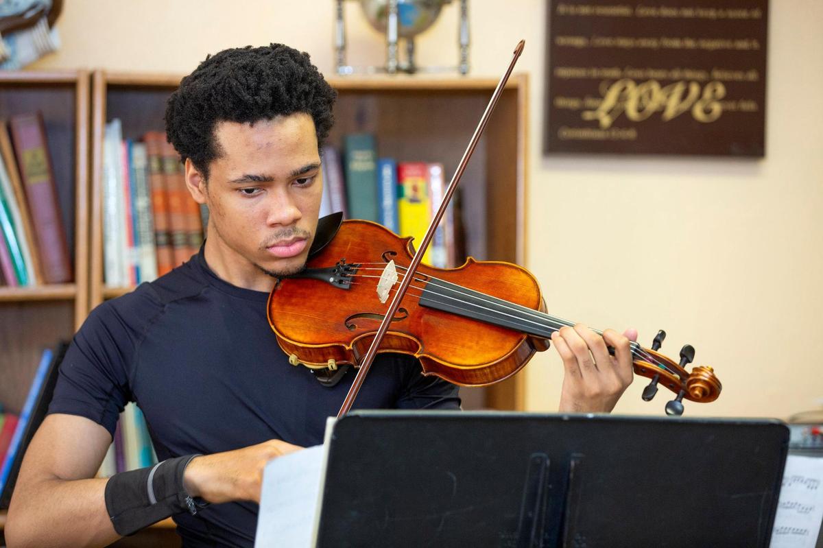 Jonathan Ellison, 22 during a strings practice session for the A-Flat Youth Orchestra Saturday, May 31, at Jamison Memorial Temple CME Church in Kansas City.