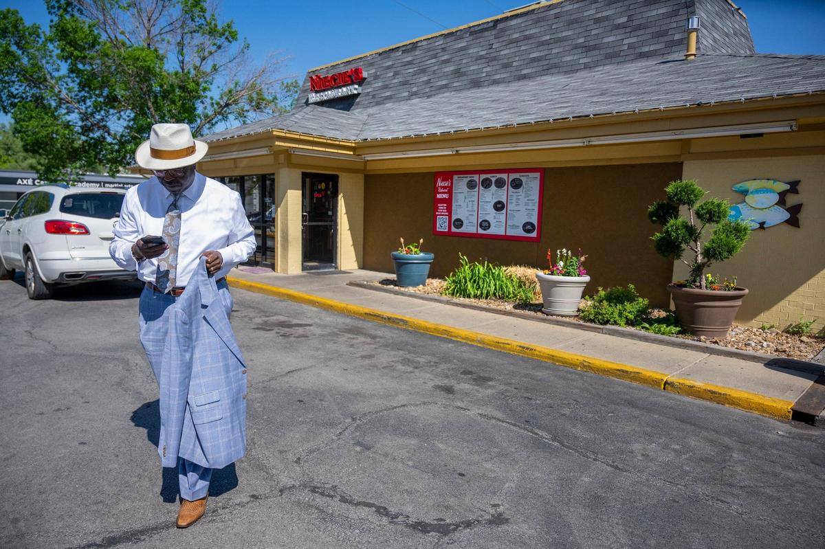 Bob Kendrick, president of the Negro Leagues Baseball Museum, checks his phone as he leaves Niecie’s Restaurant, 6441 Troost Ave.