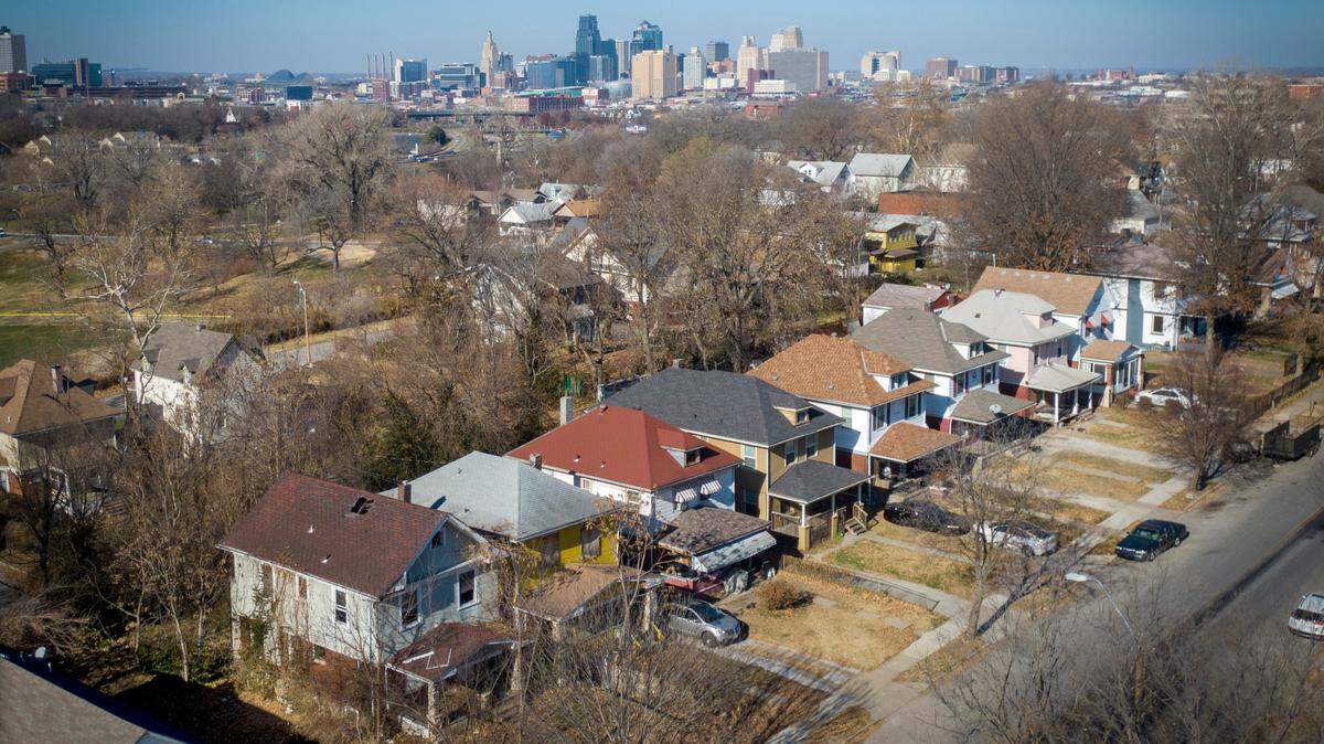 Records show a string of seven properties along Brooklyn Avenue at 27th Street are held by owners from, left to right, Atlanta, Georgia (empty lot); The Land Bank of Kansas City; Loman, Idaho; owner-occupied; Broken Arrow, Oklahoma; a Kansas City resident living elsewhere; a Kansas City LLC.