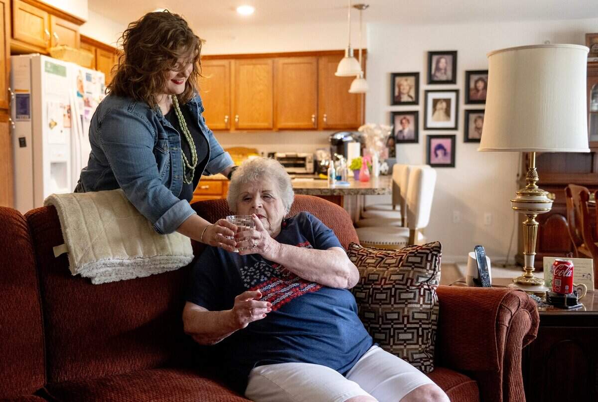 Death doula Ashley Boydston gave a glass of water to Jeannine Binder after the two women took a walk outside Binder’s home in Shawnee.