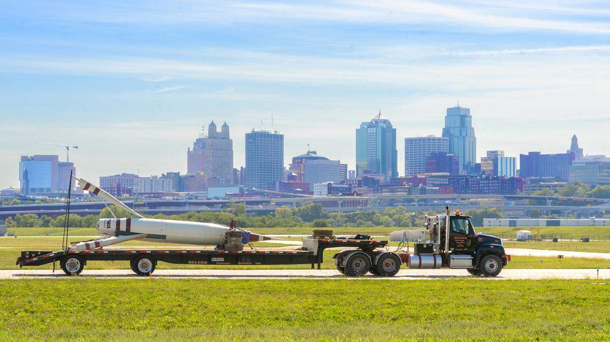 A Belger Cartage truck begins the move of the TWA Moonliner II from the Airline History Museum across Wheeler Field to the TWA Museum on Saturday. The Moonliner II is a scaled down replica of the TWA Moonliner rocket that was part of a display at Disneyland inviting visitors to imagine a world of space travel.