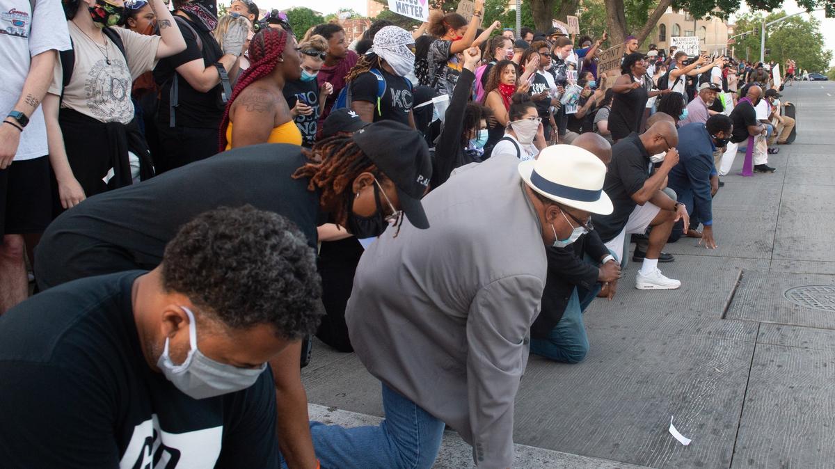 Religious leaders joined the protesters Tuesday at the George Floyd protest at the Country Club Plaza where they kneeled together.