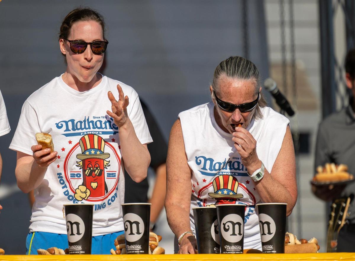 Kelsi Hunner , left, of Lee’s Summit and Lisa Cowan of Leawood ate hot dogs during Nathan’s Hot Dog Eating Contest at Old Shawnee Days on Saturday, June 7, 2025, in Shawnee. Hunner ate 6, while Cowan downed 7.5 hot dogs in the 10 minute contest.