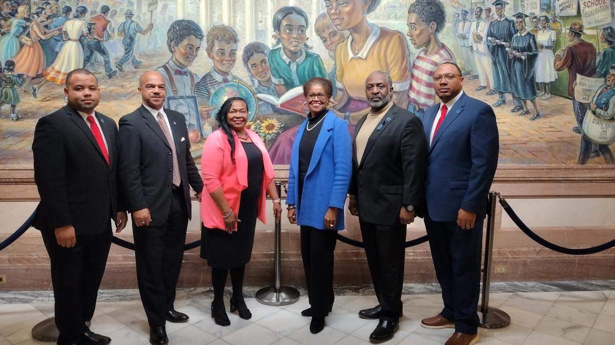 Members of Kansas’ African American Legislative Caucus (Rep. Patrick Penn, Sen. David Haley, Sen. Oletha Faust-Goudeau, Rep. Barbara Ballard, Rep. Ford Carr and Rep. Brad Boyd) pose in front of the state’s Brown v. Board of Education mural. (Courtesy of Rep. Patrick Penn)