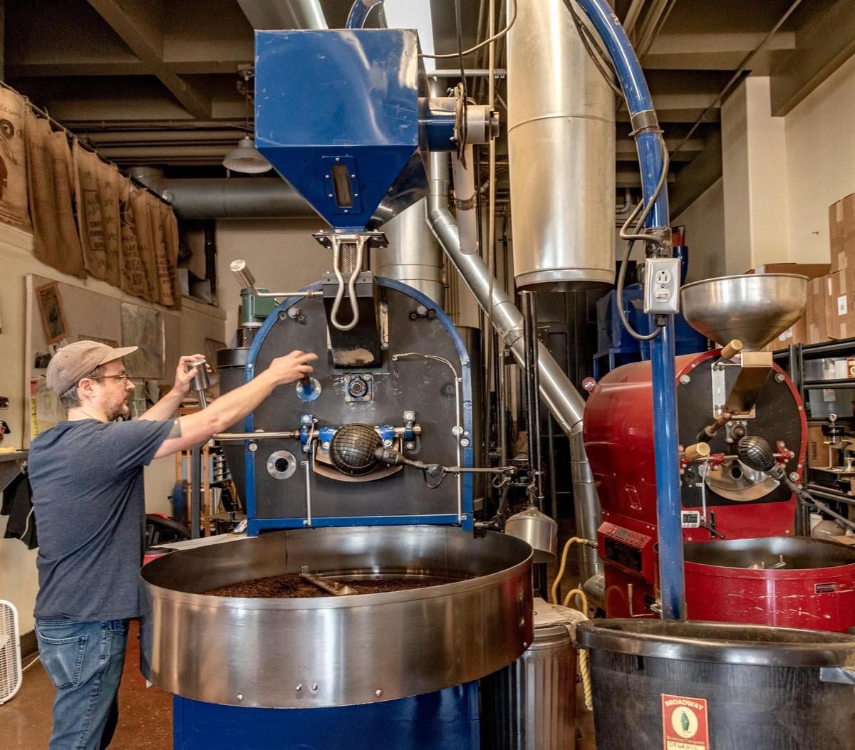 John Greiner starts the coffee roaster at Broadway Roasting Co. The roasting operation moved to its own building, an old fire station, in 2007.