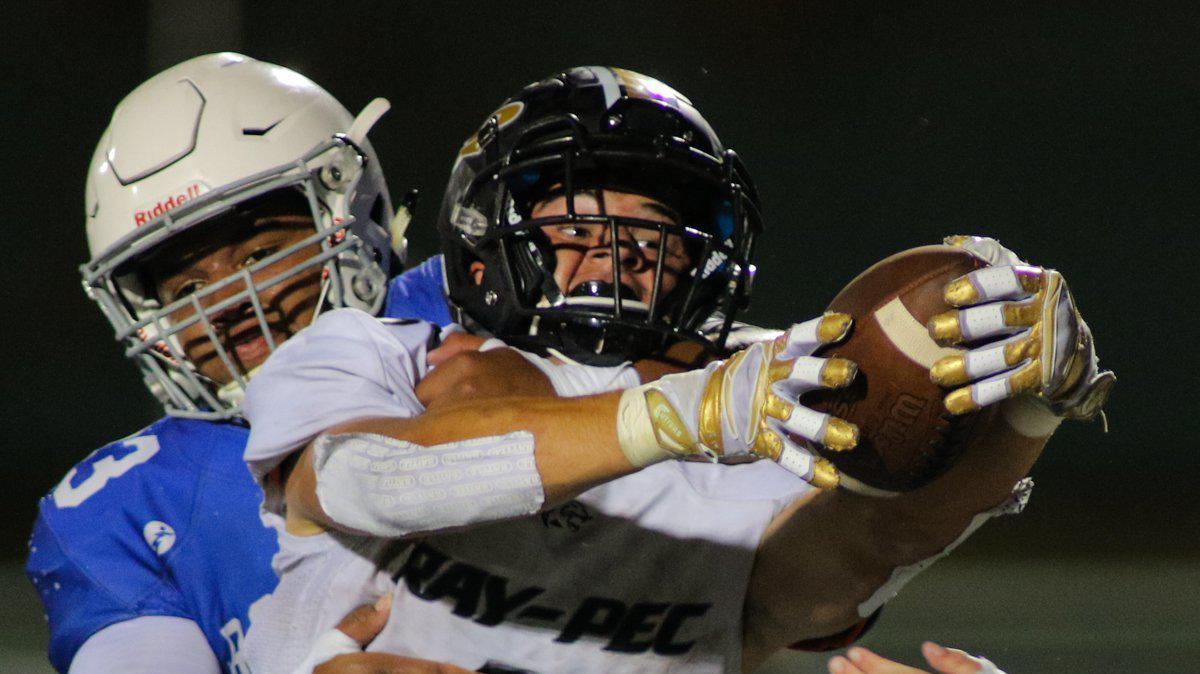 Raymore-Peculiar running back Phillip Fager stretches the ball across the goal line for a touchdown Friday night against Rockhurst at Severino Field. The Panthers outlasted the Hawklets 42-34 to open the season.