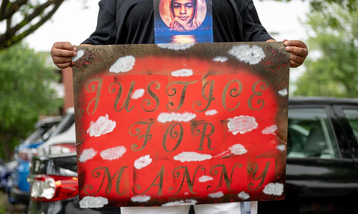 Carina Guzman holds a sign during a protest outside of the Jackson County Family Court on Friday, May 12, 2023, in Kansas City. Guzman’s nephew, Manuel, was stabbed to death by another student at Northeast Middle School in 2022. Family members and friends gathered to protest the plea deal offered to the young boy who killed Manuel.