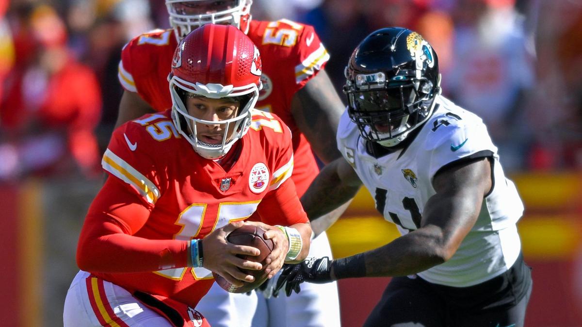 Chiefs quarterback Patrick Mahomes (15) scrambles as he pressured by Jacksonville Jaguars linebacker Josh Allen (41) during the first half against on Sunday, Nov. 13, 2022, at Arrowhead Stadium in Kansas City.