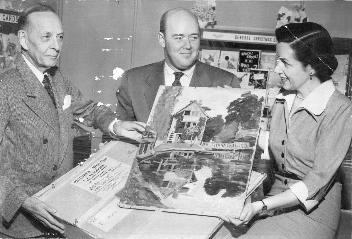 In this 1950 photo, Hallmark executives R. B. Hall, William R. McCloskey, and Virginia Hogan examine Winston Churchill’s painting Mill Pond With Reflection on Water. The artwork was the first of eight Churchill paintings considered for reproduction on Hallmark Christmas cards.