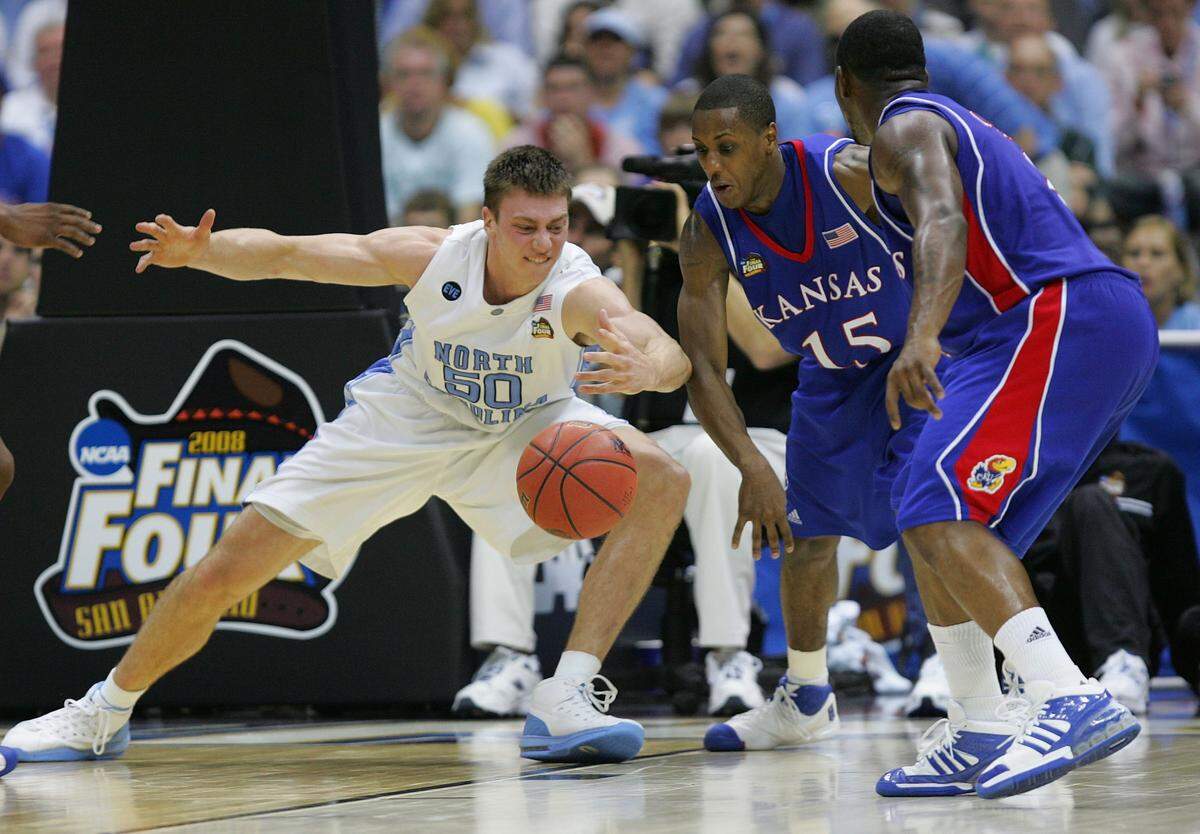 Tyler Hansbrough #50 of the North Carolina Tar Heels reaches for a loose ball against Mario Chalmers #15 of the Kansas Jayhawks in the second half during the National Semifinal game of the NCAA Men's Final Four at the Alamodome on April 5, 2008 in San Antonio, Texas.