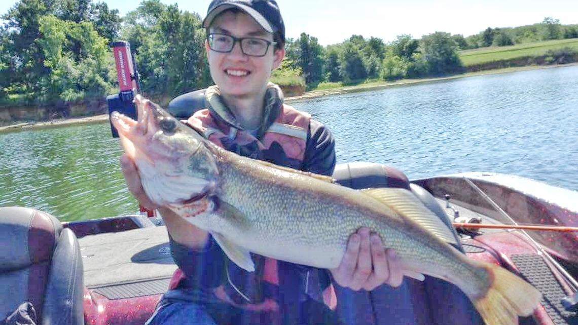 Hank, grandson of Gary Burton at Burton's Bait and Tackle in Smithville, hoists a 6-pound walleye that measured 26 inches.