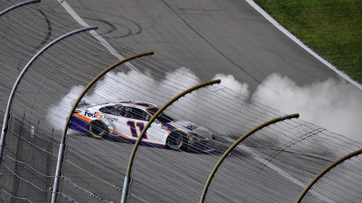 Denny Hamlin (11) burns out after finishing first in the Super Start Batteries 400 presented by O’Reilly Auto Parts at the Kansas Speedway Thursday, July 23, 2020.