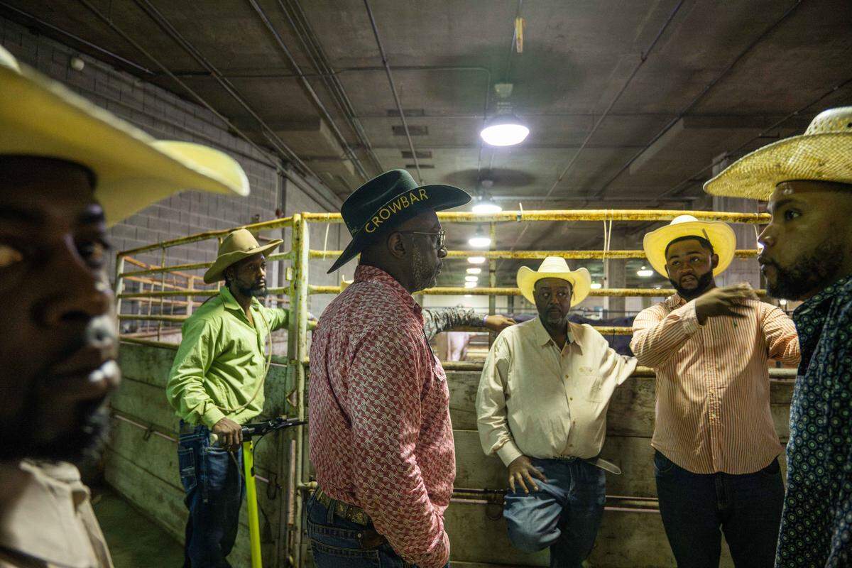 Black Rodeo USA arena director Troy Ford settles a dispute amongst cowboys prior to the start of Black Rodeo USA, inside the American Royal in Kansas City on Saturday, July 26, 2025. Rodeo performers from across the country traveled to showcase their skills at the rodeo, the first Black rodeo held in Kansas City in years.
