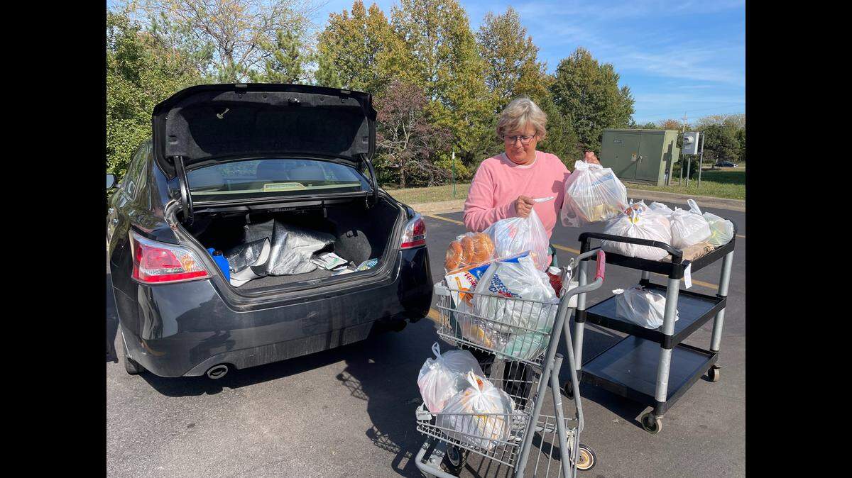 Volunteer Kristi Keeton worked a shift at New Hope Food Pantry in Olathe, filling vehicles with food. During the government shutdown and amid federal cuts, pantries like this one in Olathe are helping families and seniors at a critical time.