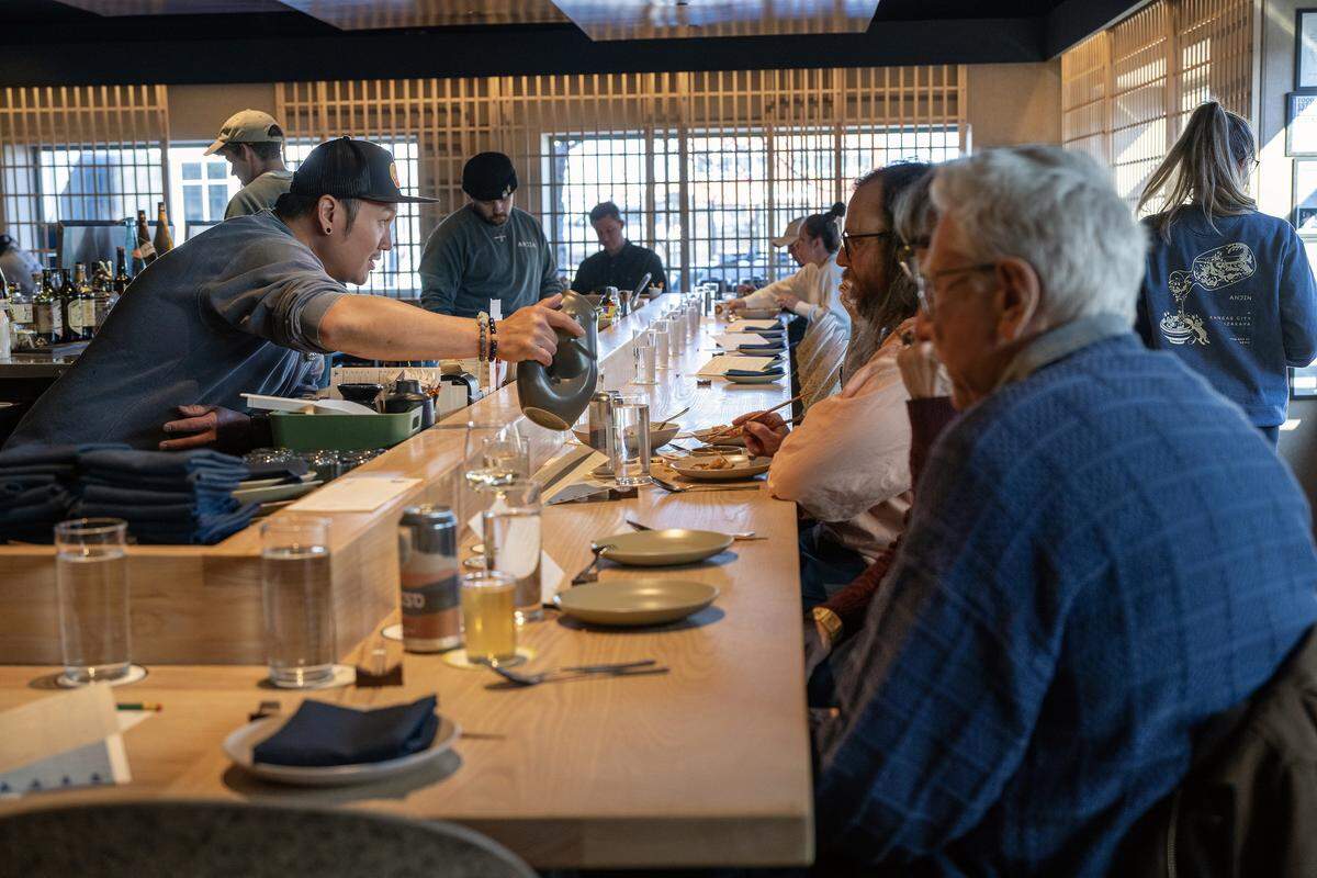 Server James Chang refills water for diners at Anjin, a 20-seat Japanese Izakayas-style restaurant, on Monday, March 16, 2026, in Kansas City.