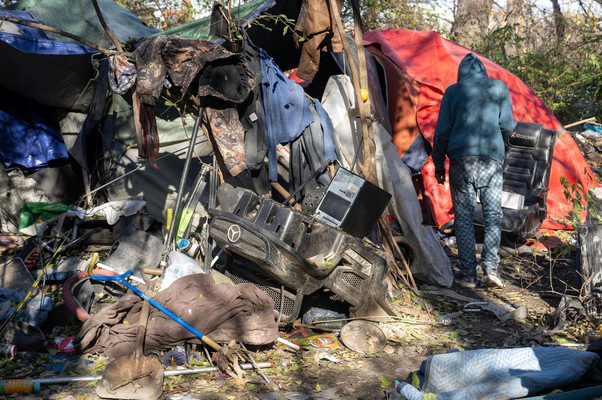 Tommy heads backs to his shelter in a homeless camp in the trees along the railroad north of Kansas City’s Columbus Park.
